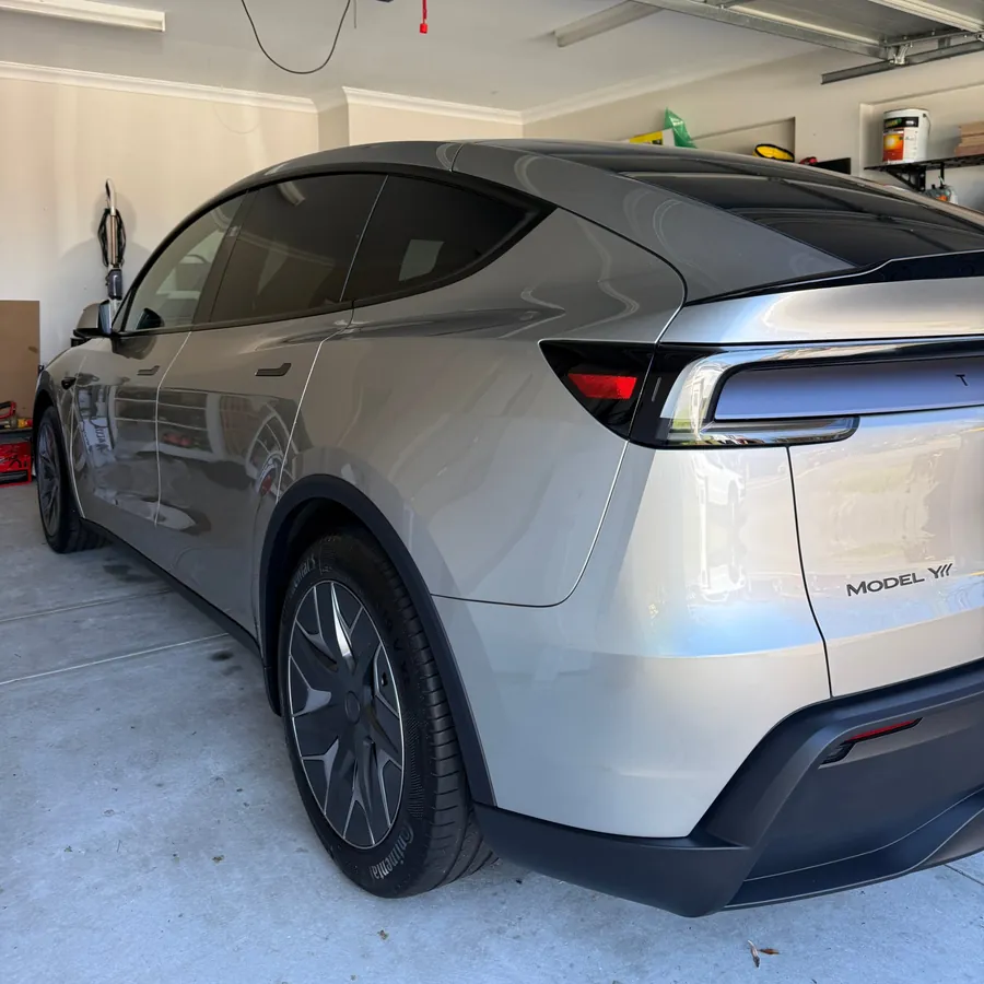 Ceramic coated silver Tesla Model Y showing glass roof and aero wheel covers in a Perth garage